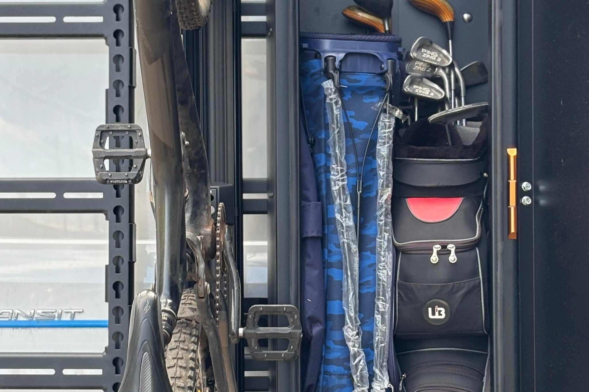 Close view of an exterior storage box and gear carrier fitted at the rear of a Sprinter