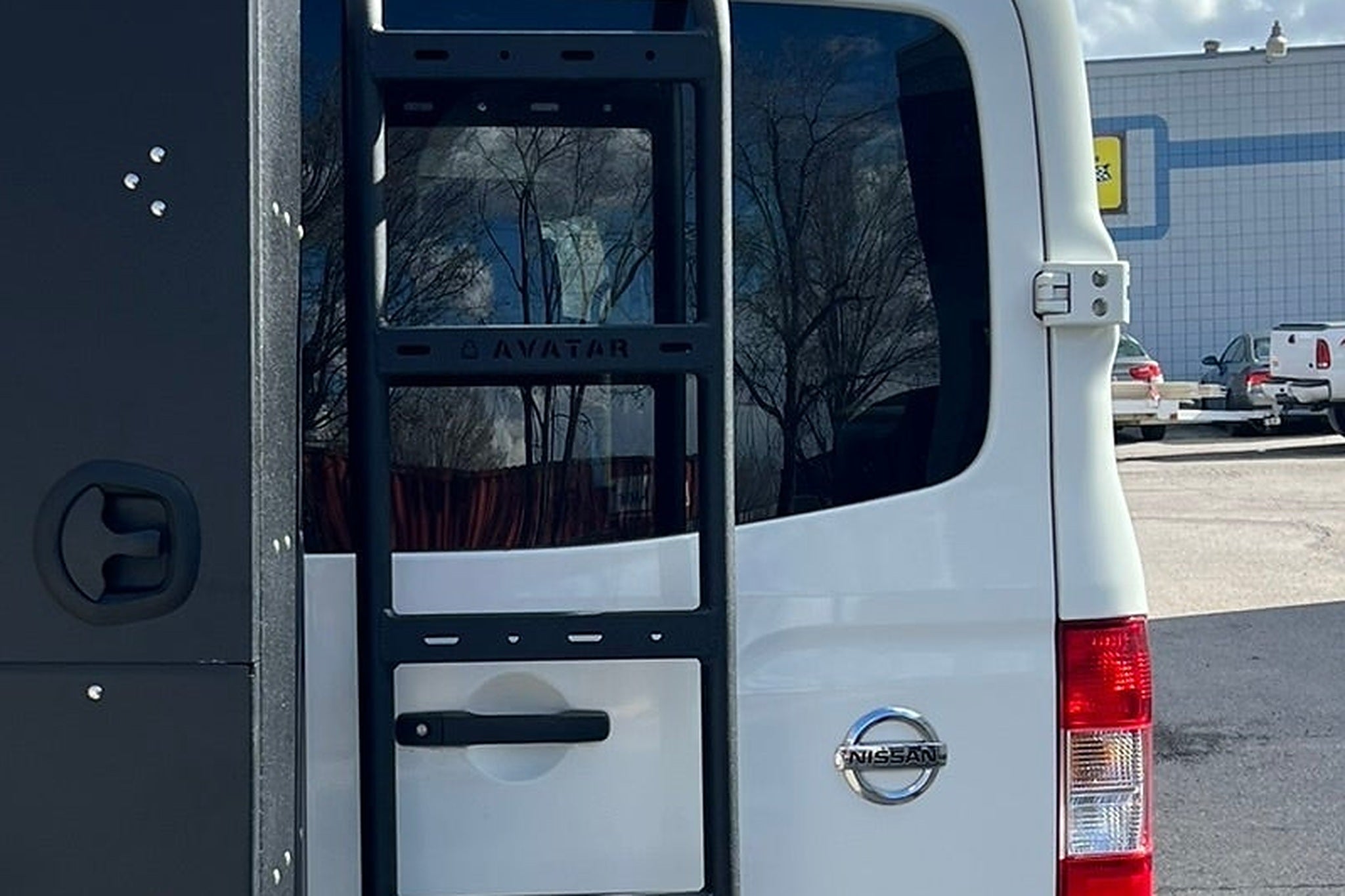 Close view of a lockable exterior storage box fitted at the rear of a van