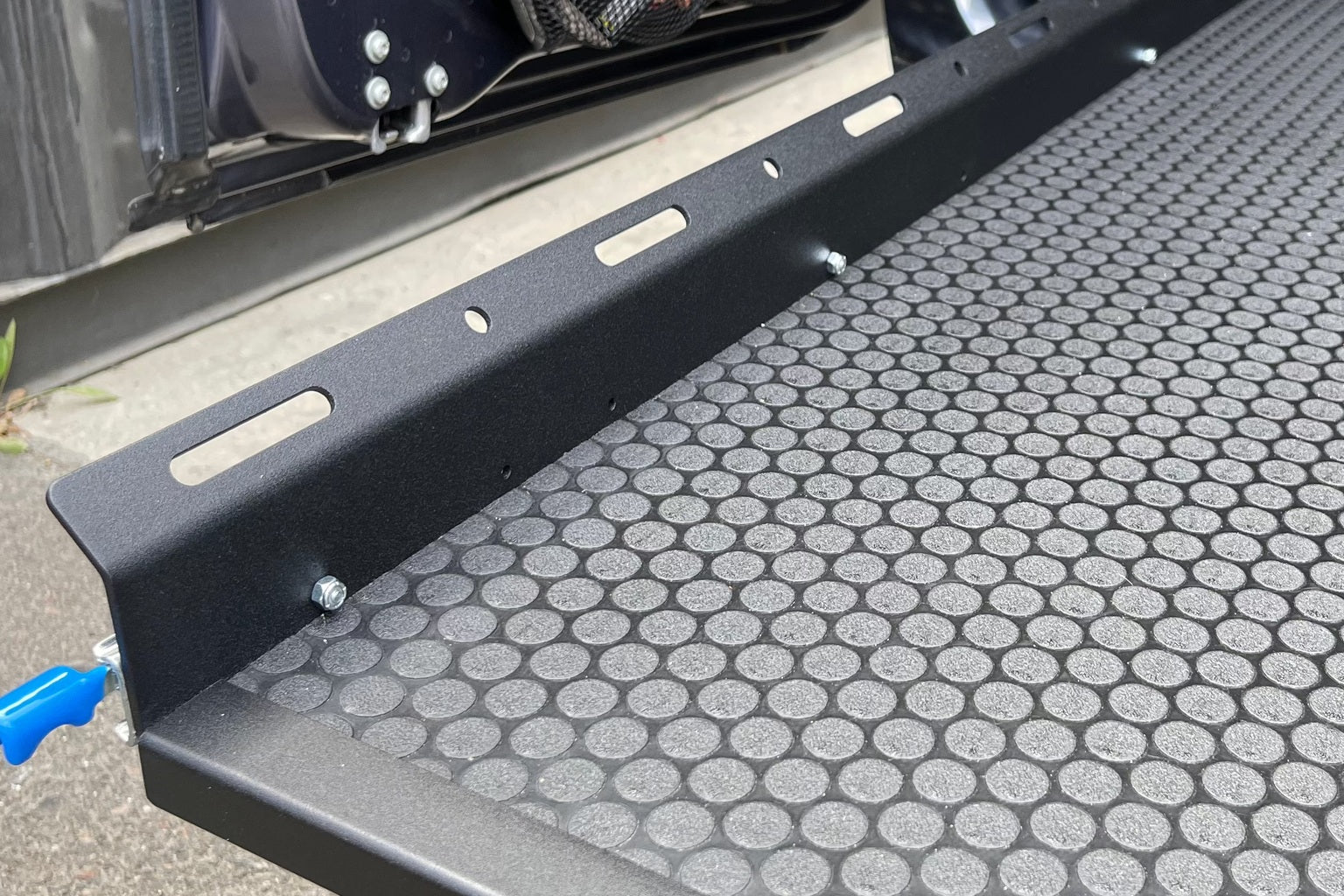 A full extension slide tray with a timber deck pulled out from the rear of a high-roof cargo van