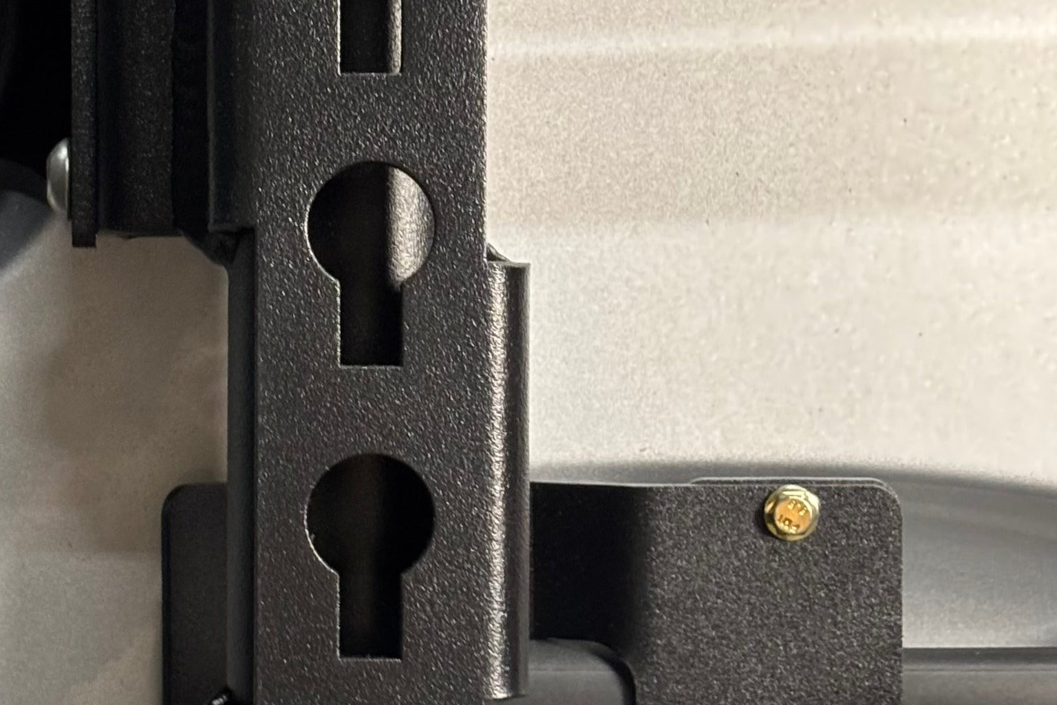 Keyhole mounting rail hardware detail on a van storage box