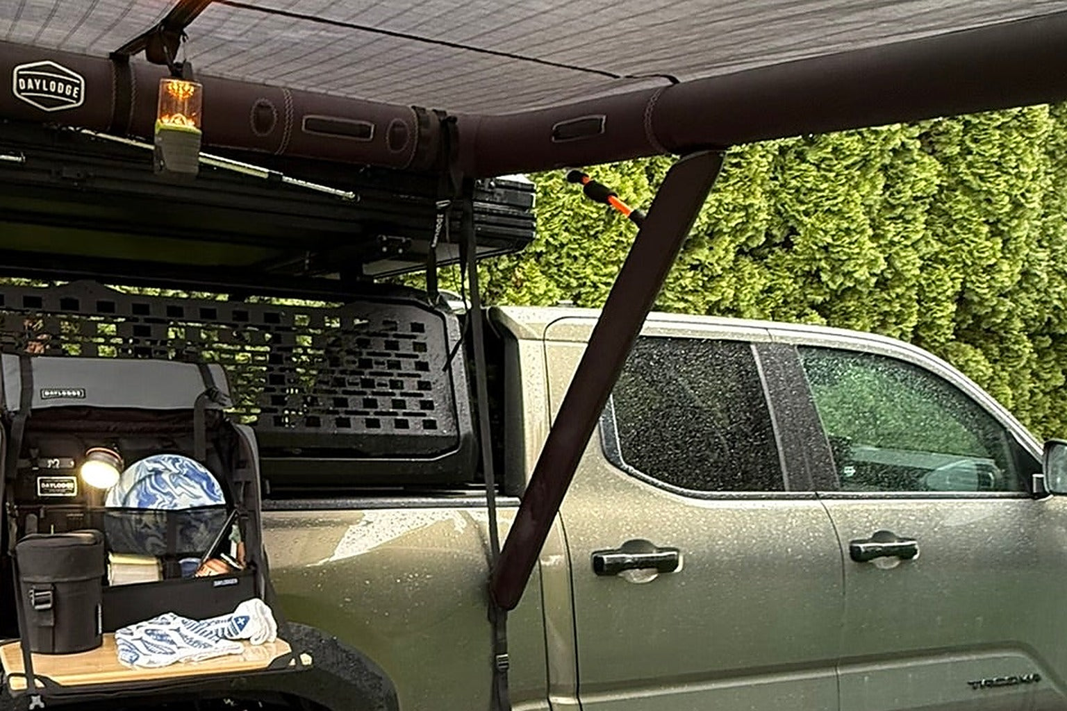 Pickup truck with bed rack and MOLLE panel under a vehicle shelter