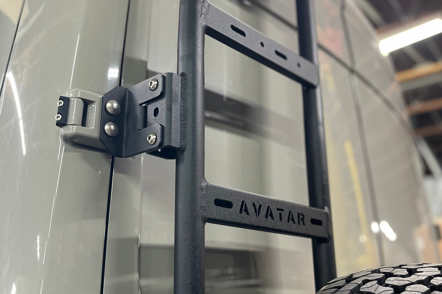 A Mercedes Sprinter outfitted with a platform roof rack, rear door cabinets and interior shelving at a mountain pullout