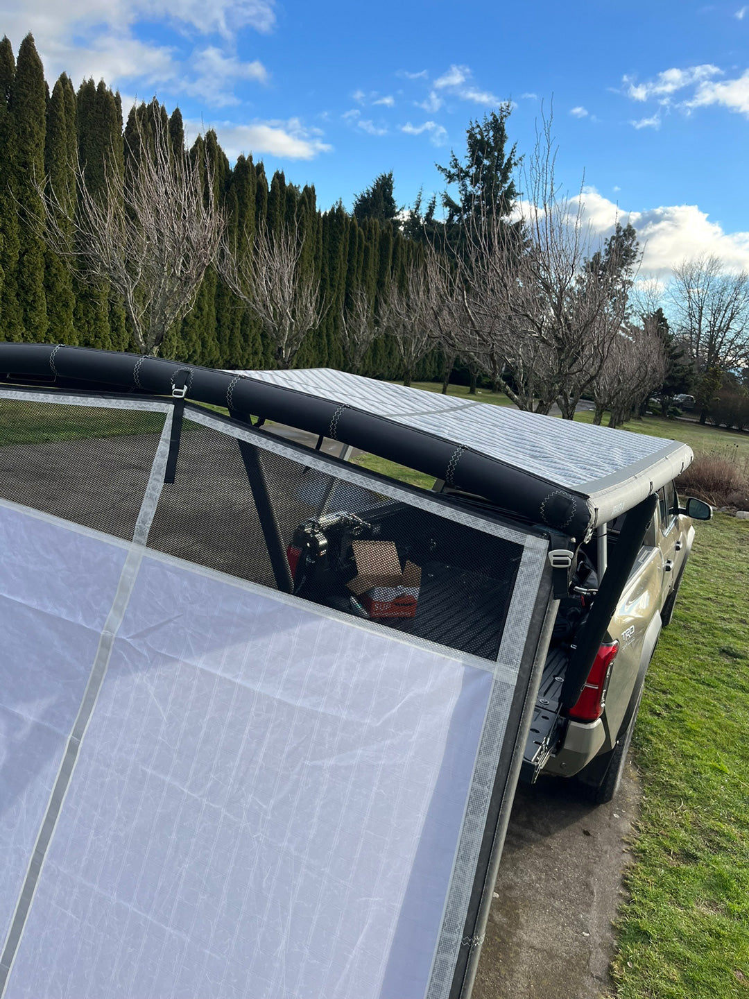Alternate angle on the DAYLODGE AirHaven 40 Annex Wall Kit, part of a vehicle based camp and travel setup