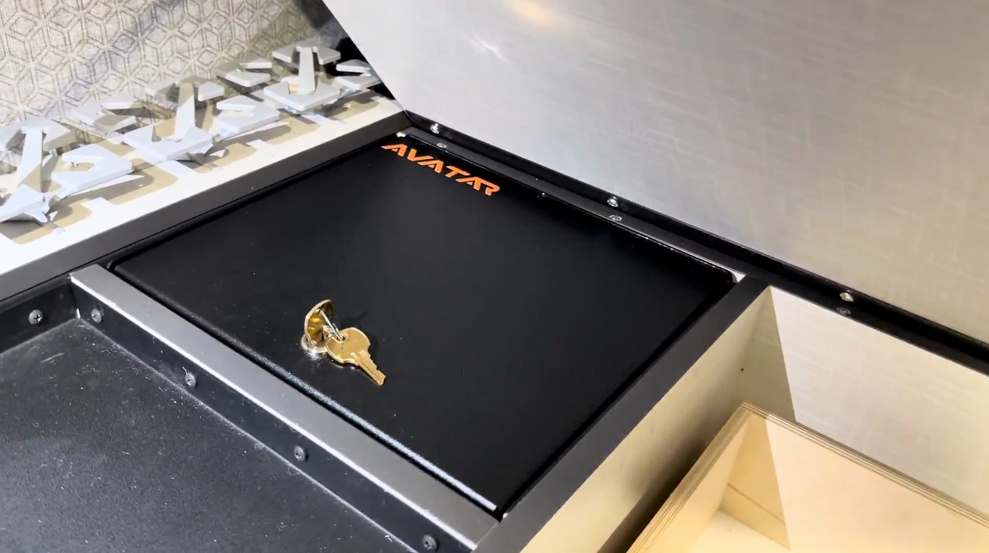 Product view of the Avatar Offroad Ekko Under Bed Locking Storage Door, fitted to an overland van build