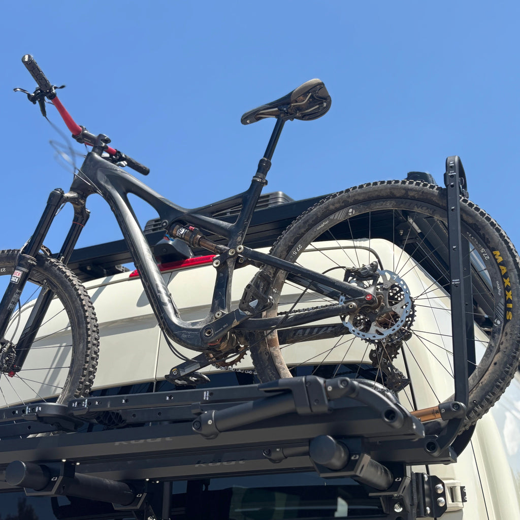 In use view of the Avatar Offroad Bike Posts for the Massif System, part of the Avatar Offroad van storage and overland range