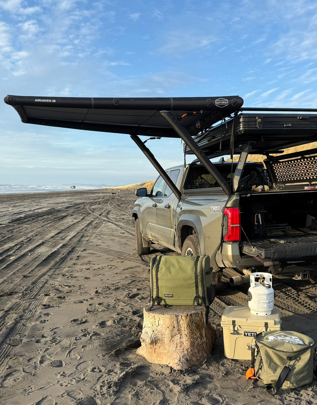 Supporting view of the DAYLODGE AirHaven 40 Vehicle Shelter System, part of a vehicle based camp and travel setup