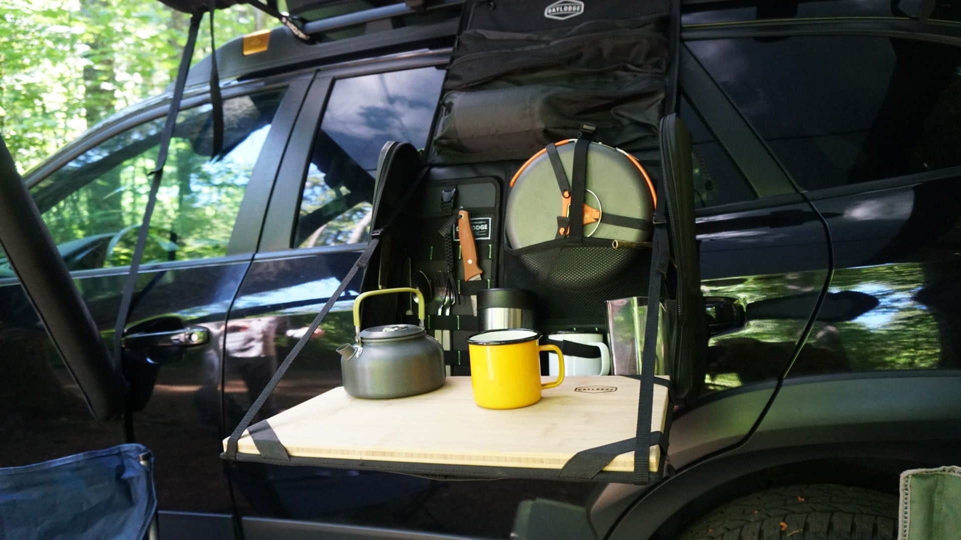 Supporting view of the DAYLODGE Workspace Mobile Camp Kitchen, part of a vehicle based camp and travel setup
