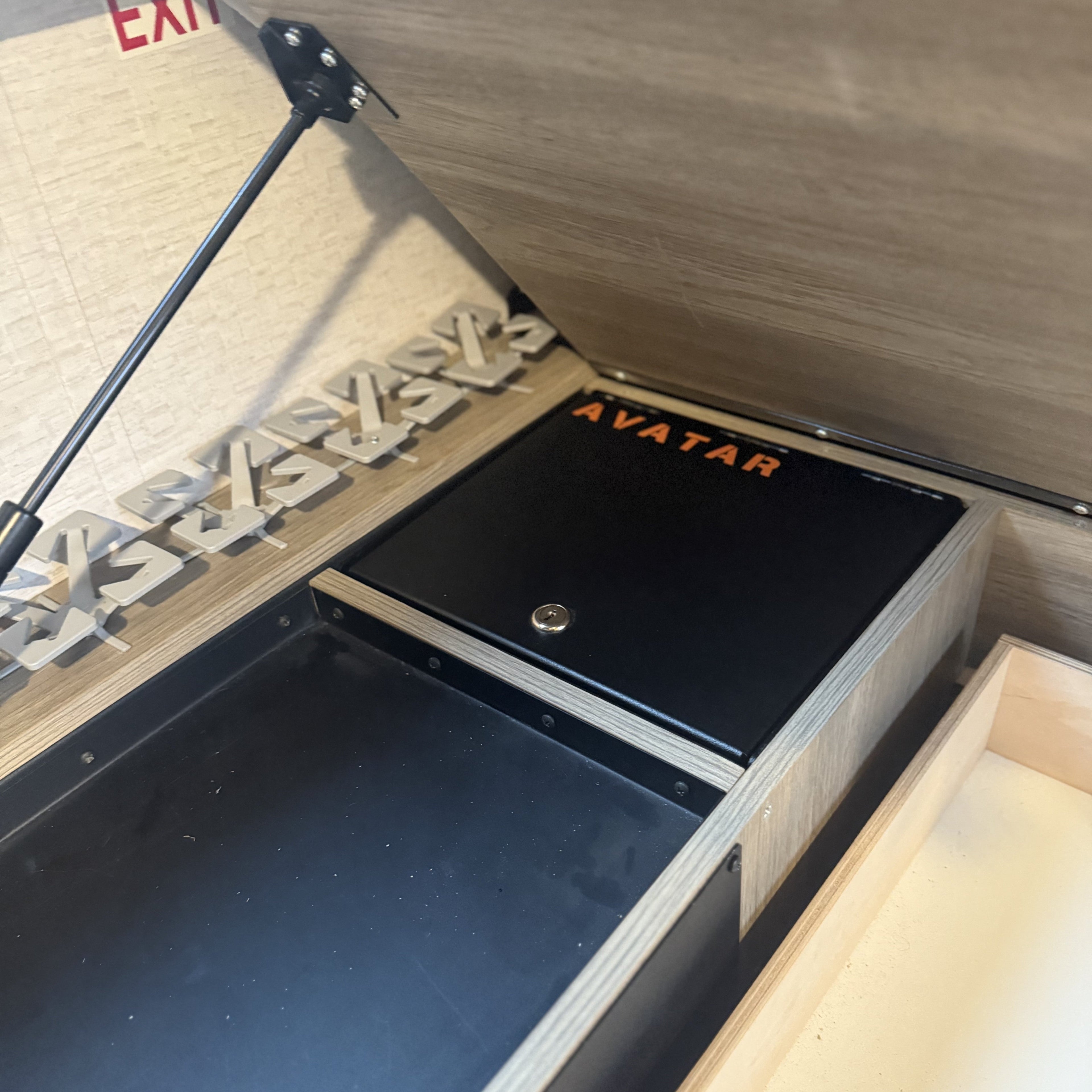 Closed view of the Avatar Offroad Ekko Under Bed Locking Storage Door, fitted to an overland van build