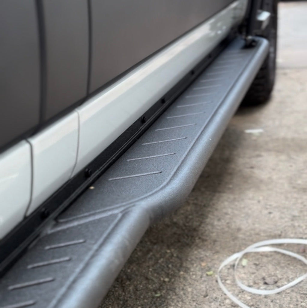 Avatar Offroad Rockbody side steps fitted to a Ford Transit van, black steel plates below the doors