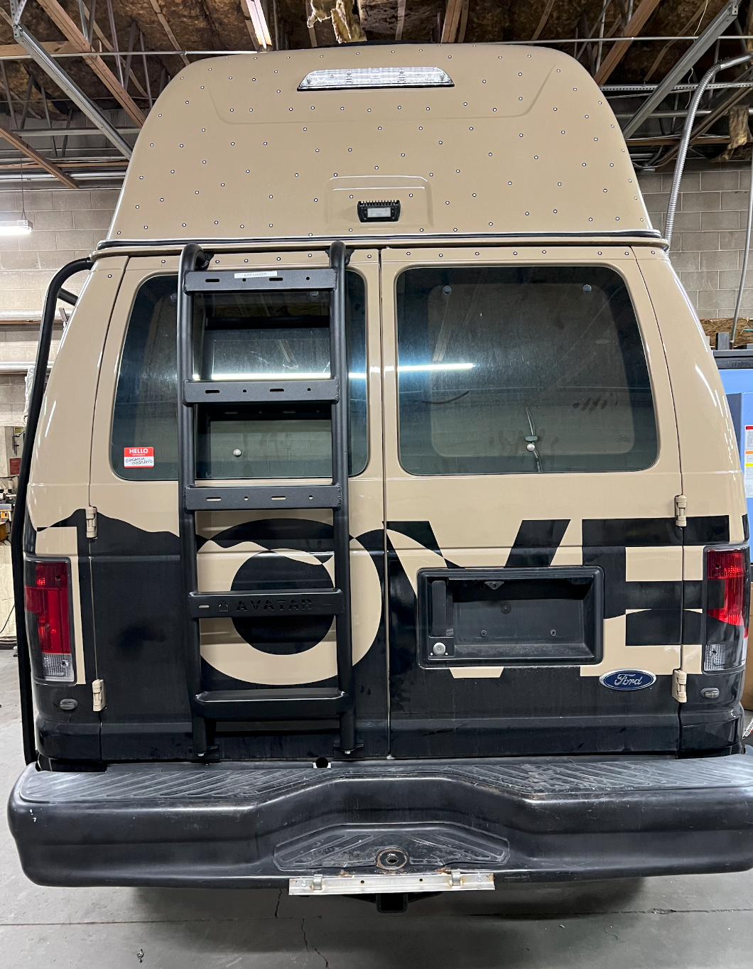 Avatar Offroad rear ladder for the Ford E-Series van mounted on the rear door in black powder coat