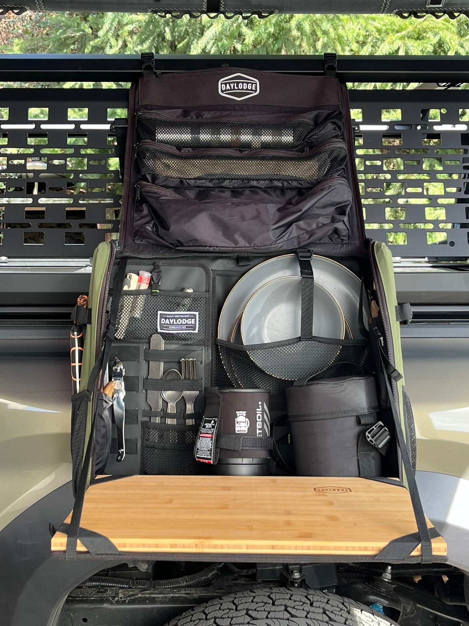 In use view of the DAYLODGE Workspace Mobile Camp Kitchen, part of a vehicle based camp and travel setup