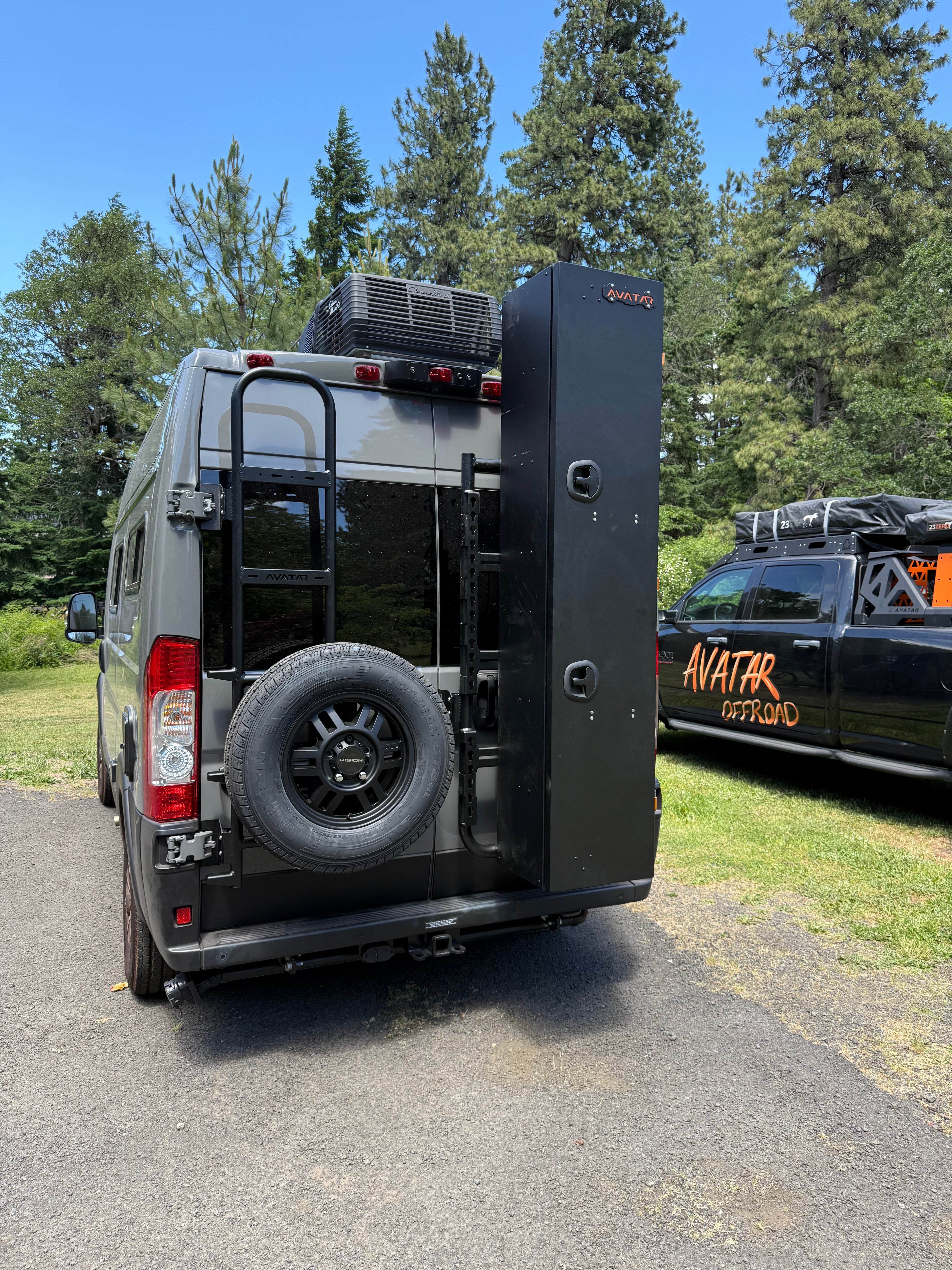 Studio view of the Avatar Offroad Rear Ladder with Tire Carrier for Vans, fitted to an overland van build