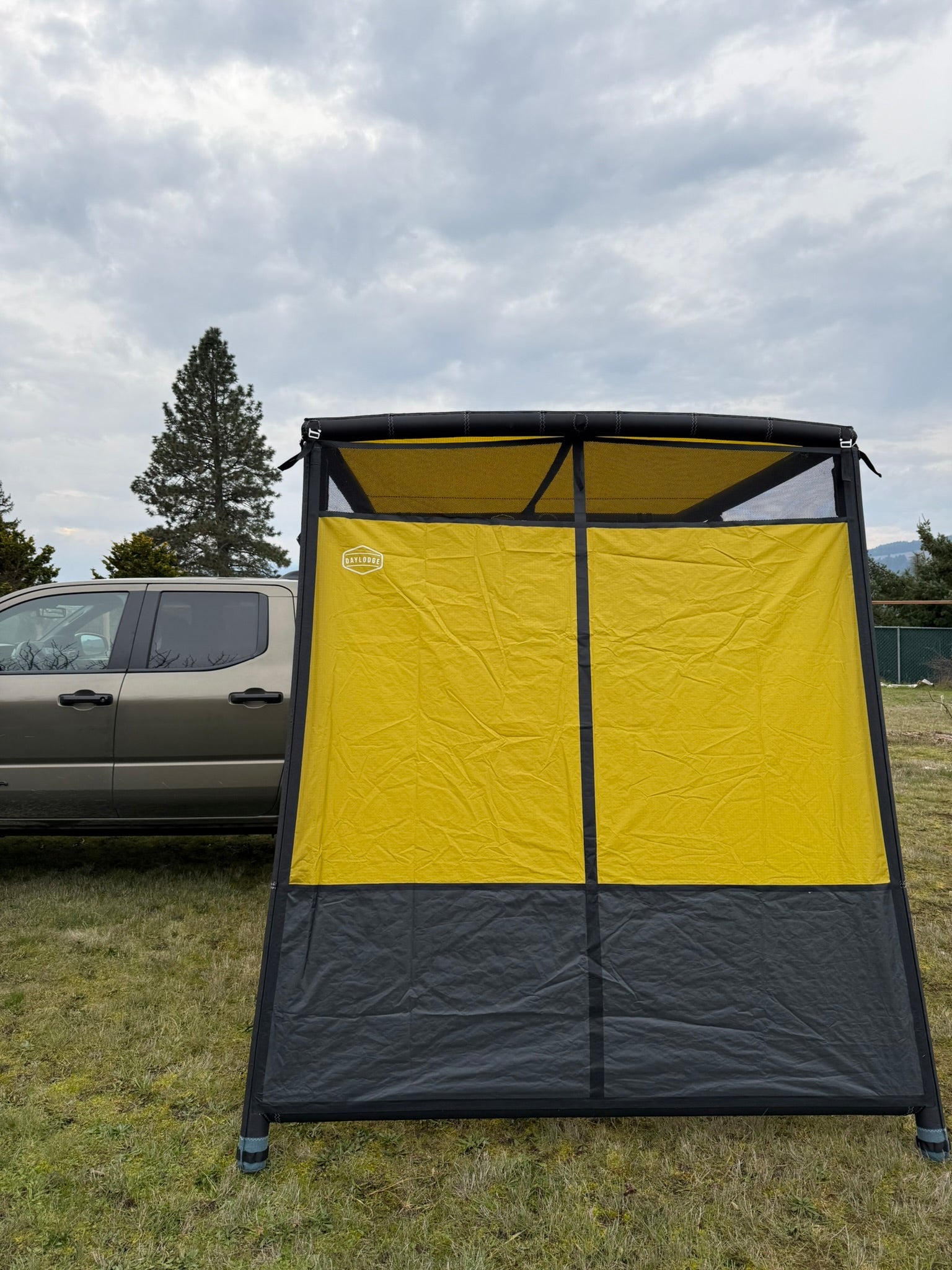 Angled view of the DAYLODGE AirHaven 40 Annex Wall Kit, part of a vehicle based camp and travel setup