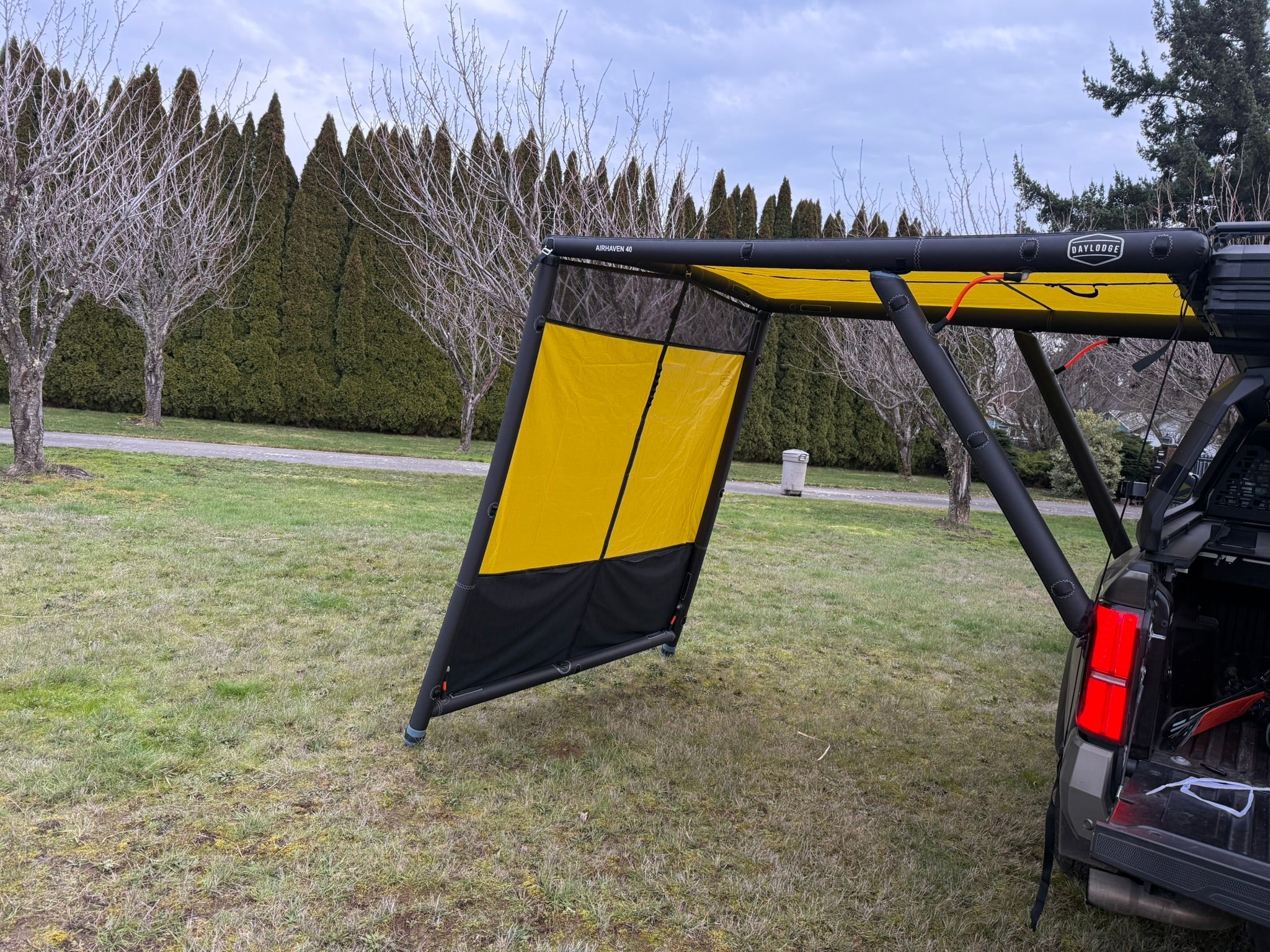 Wider view of the DAYLODGE AirHaven 40 Annex Wall Kit, part of a vehicle based camp and travel setup