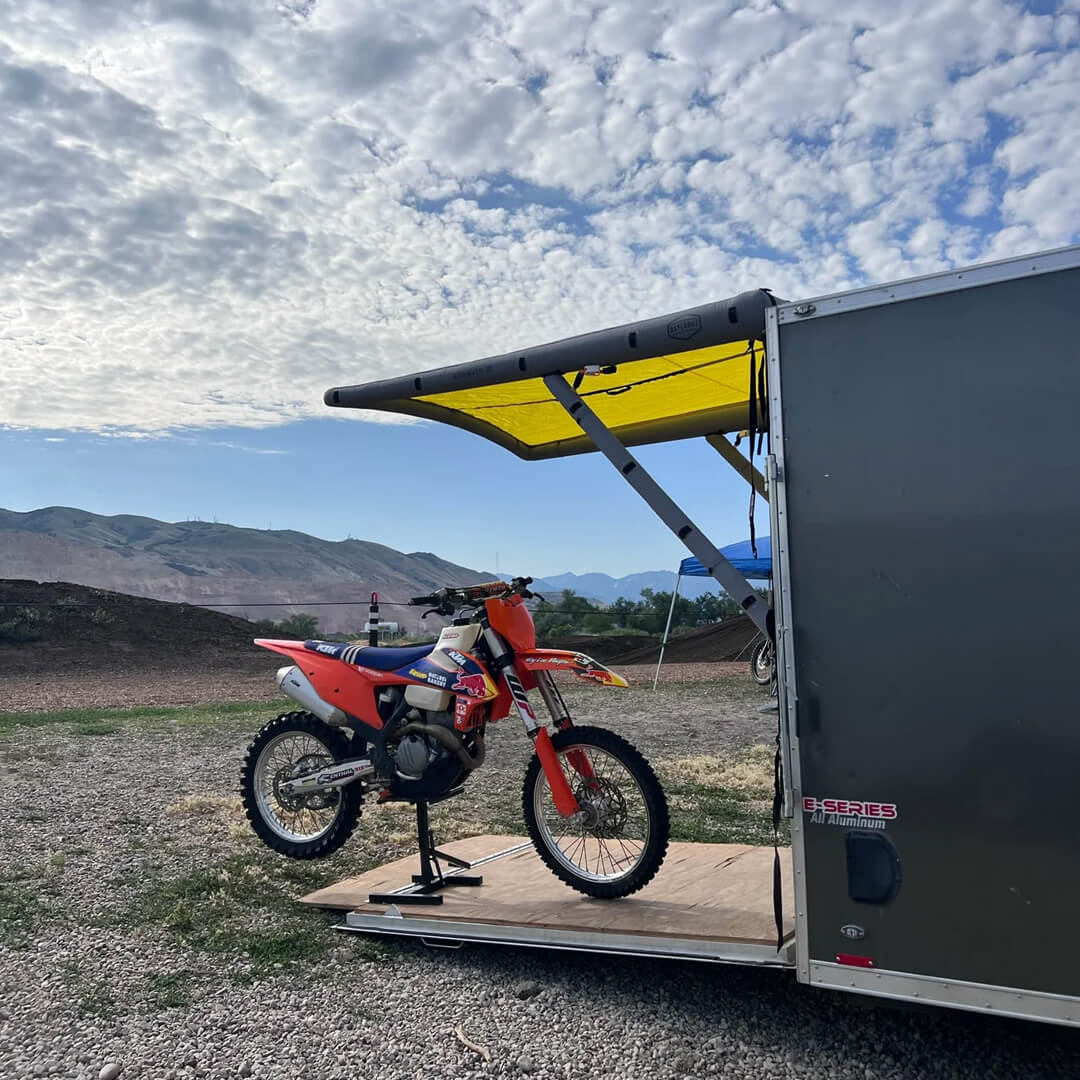 Alternate angle on the DAYLODGE AirHaven 40 Vehicle Shelter System, part of a vehicle based camp and travel setup