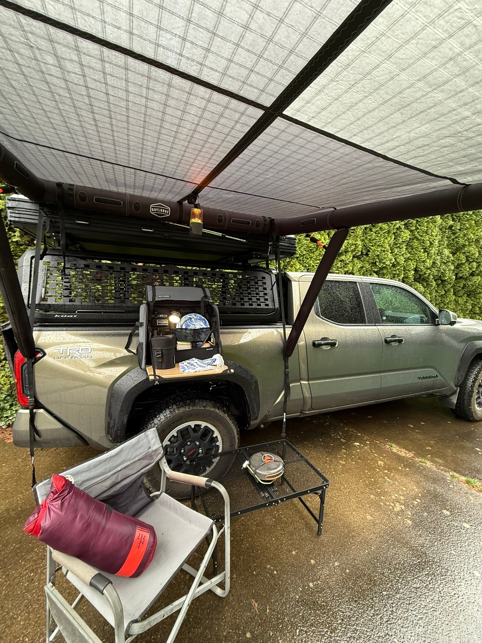 Alternate view of the DAYLODGE AirHaven 40 Vehicle Shelter System, part of a vehicle based camp and travel setup