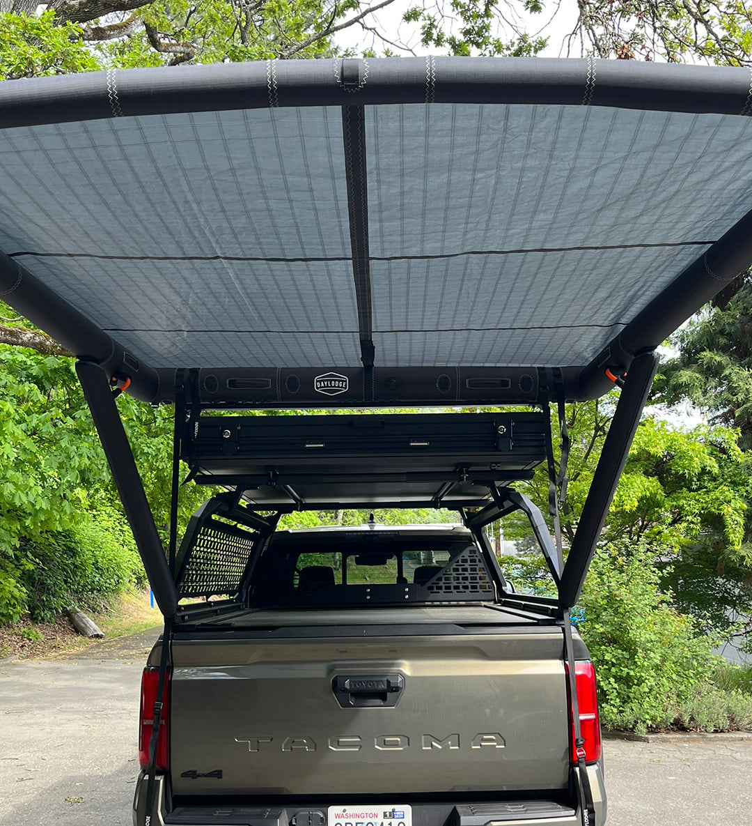 Field view of the DAYLODGE AirHaven 40 Vehicle Shelter System, part of a vehicle based camp and travel setup