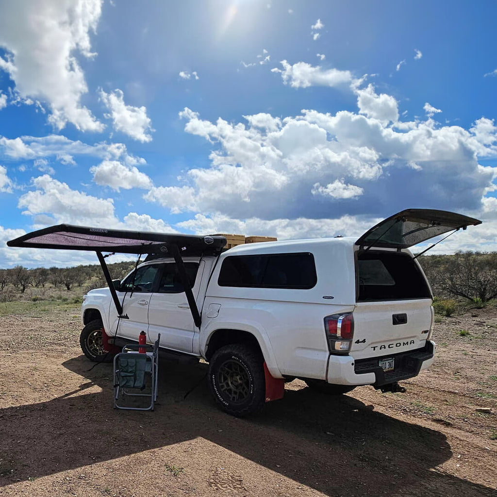 Installed view of the DAYLODGE AirHaven 40 Vehicle Shelter System, part of a vehicle based camp and travel setup