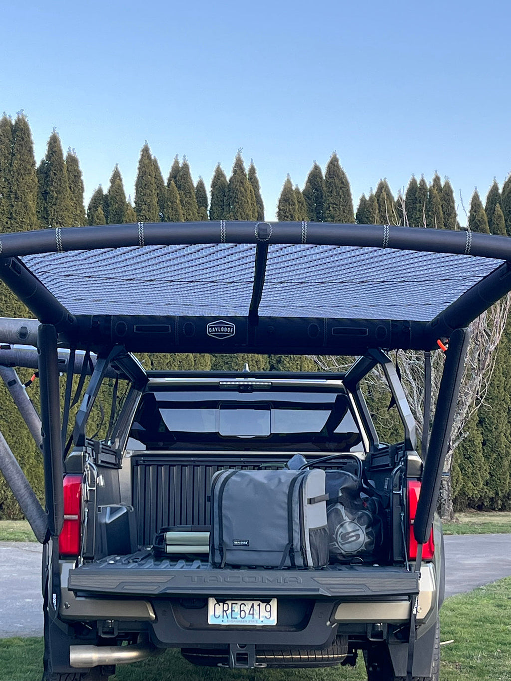 In use view of the DAYLODGE AirHaven 40 Vehicle Shelter System, part of a vehicle based camp and travel setup