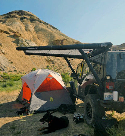 Another angle on the DAYLODGE AirHaven 40 Vehicle Shelter System, part of a vehicle based camp and travel setup