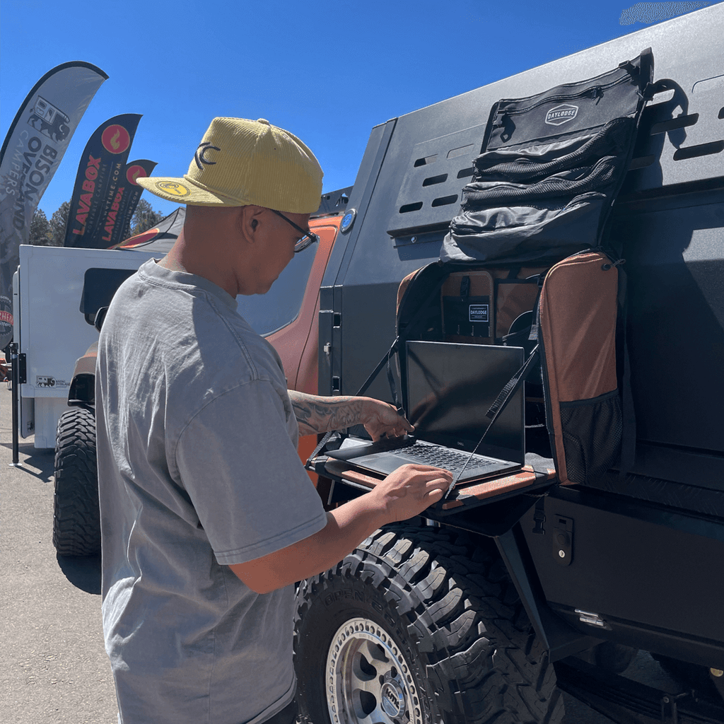 Product view of the DAYLODGE Workspace Field Bag, part of a vehicle based camp and travel setup