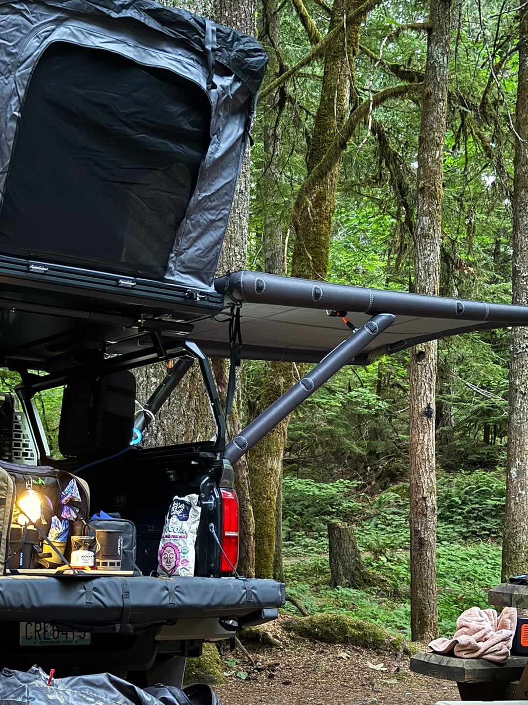 Side view of the DAYLODGE AirHaven 40 Vehicle Shelter System, part of a vehicle based camp and travel setup