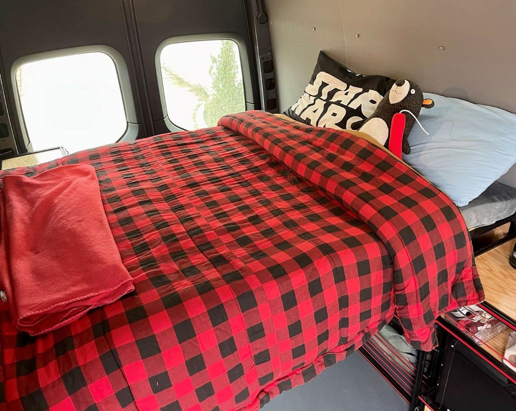 Angled view of the TNTvans 48 Inch Van Bed and Shelving Kit, part of a DIY camper van conversion interior