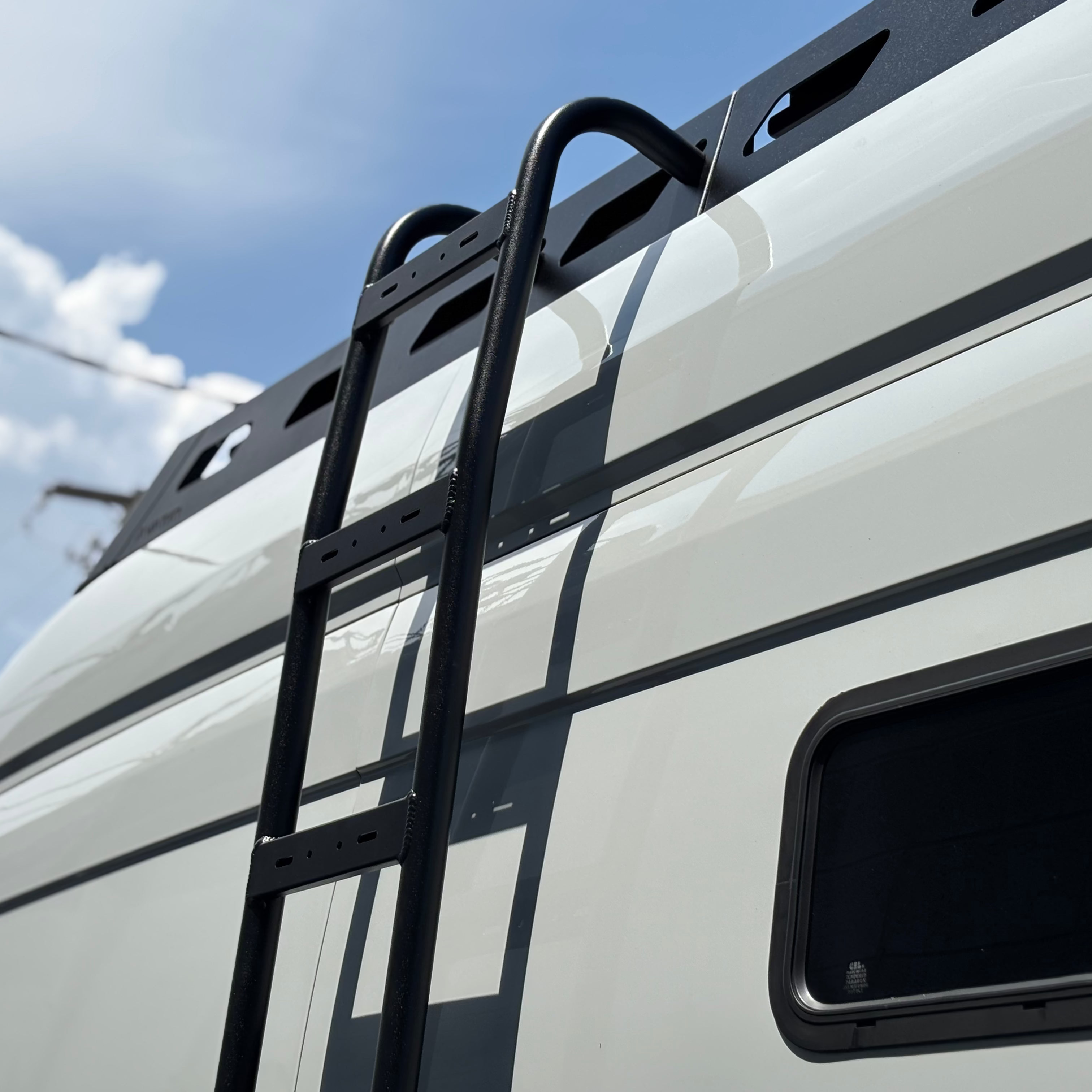 Angled view of the Avatar Offroad Pioneer Roof Rack for Ford Transit, fitted to an overland van build