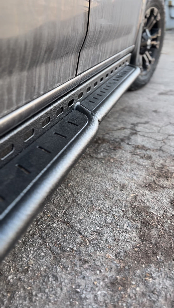 Wider view of the Avatar Offroad Rockbody Side Steps for Nissan NV3500, fitted to an overland van build