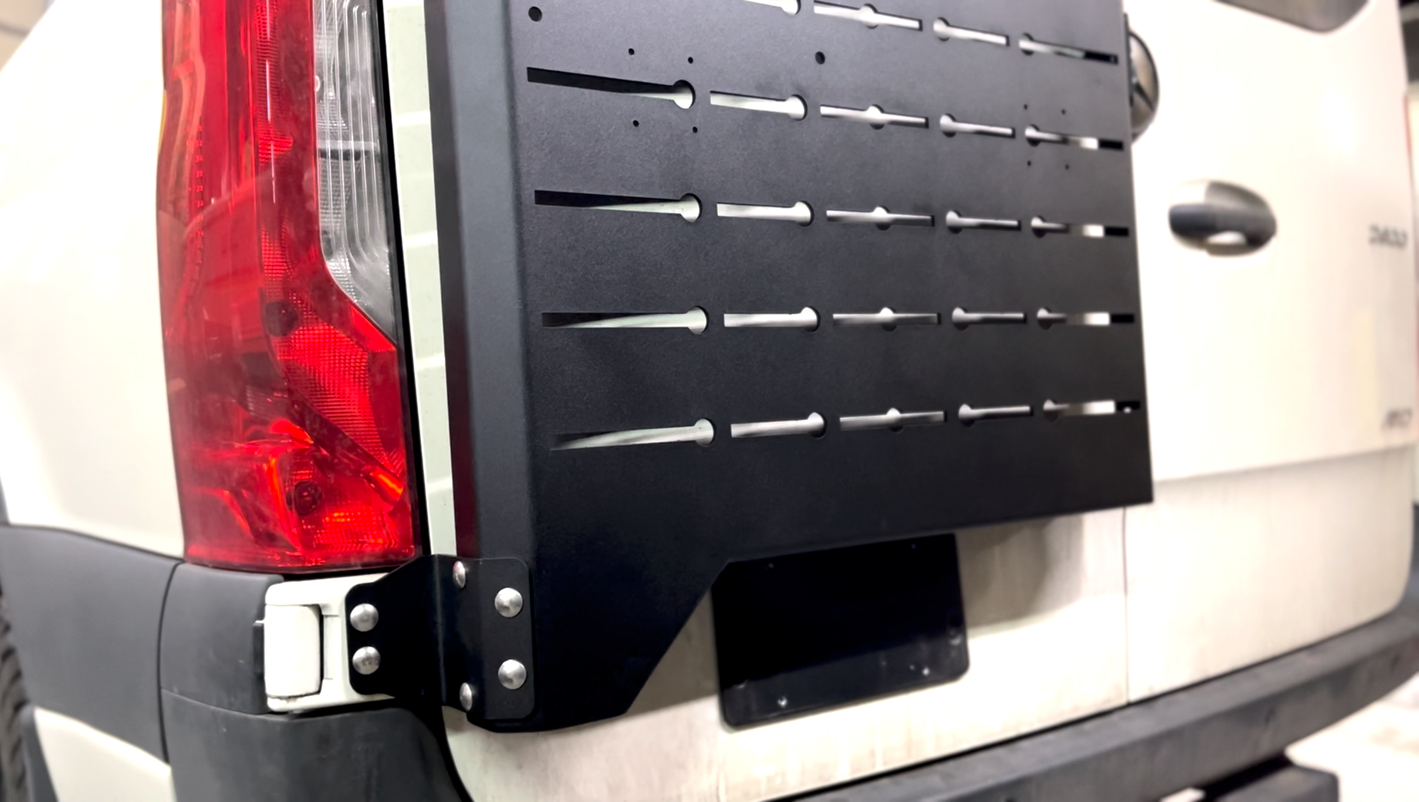 Rear view of the Avatar Offroad Sir Packs-a-lot Storage Mounting System, fitted to an overland van build