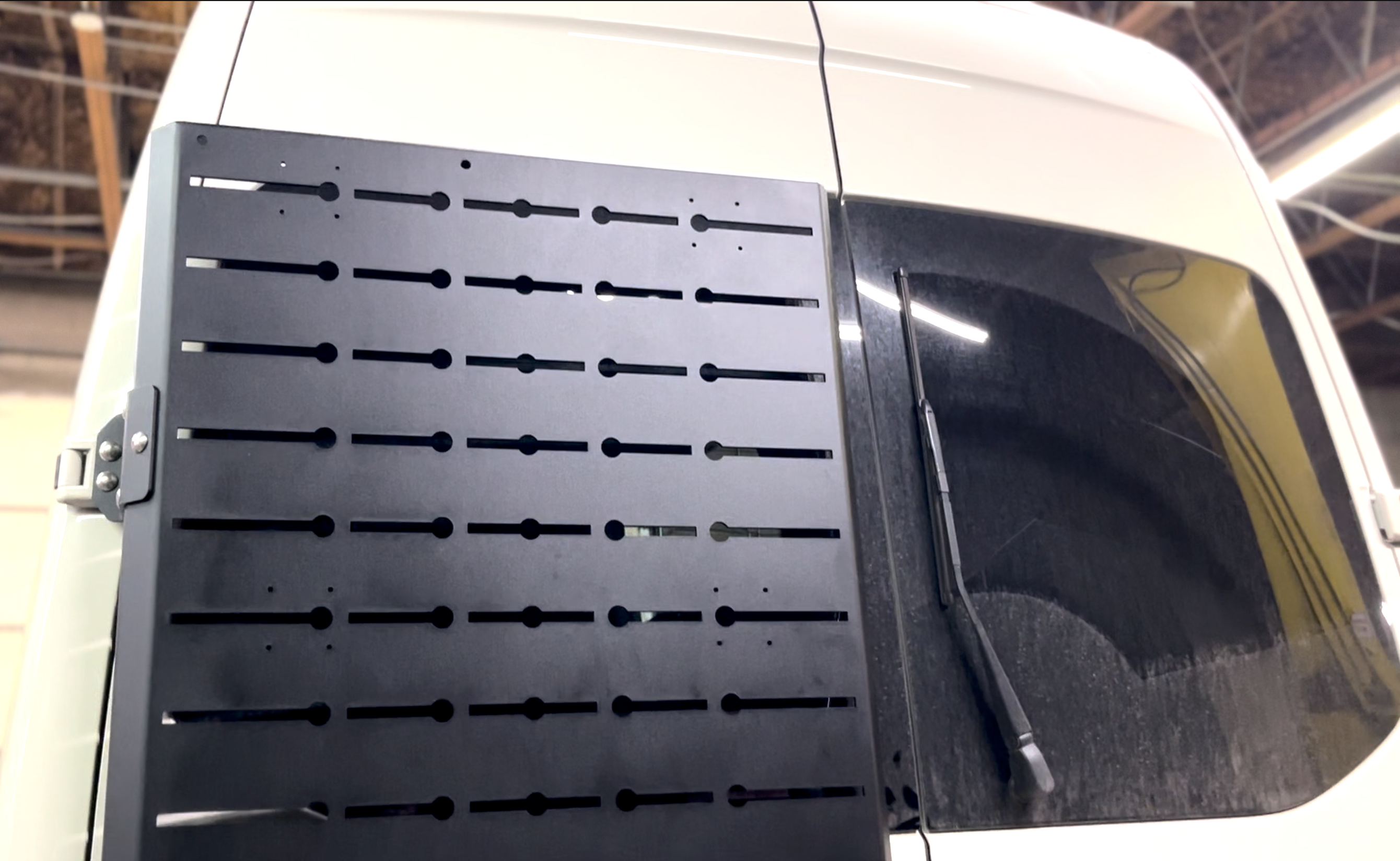 Wider view of the Avatar Offroad Sir Packs-a-lot Storage Mounting System, fitted to an overland van build
