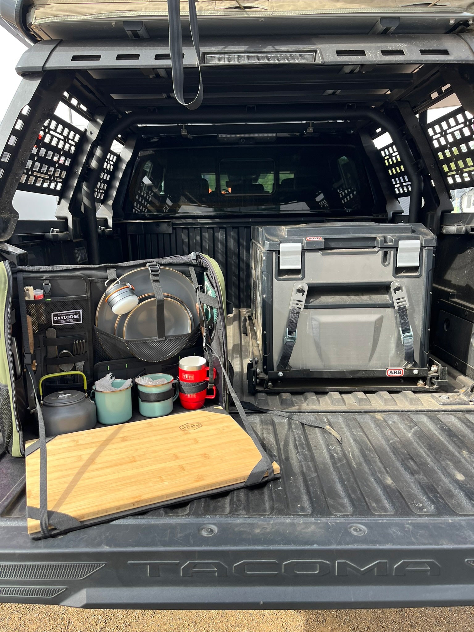 Installed view of the DAYLODGE Workspace Mobile Camp Kitchen, part of a vehicle based camp and travel setup