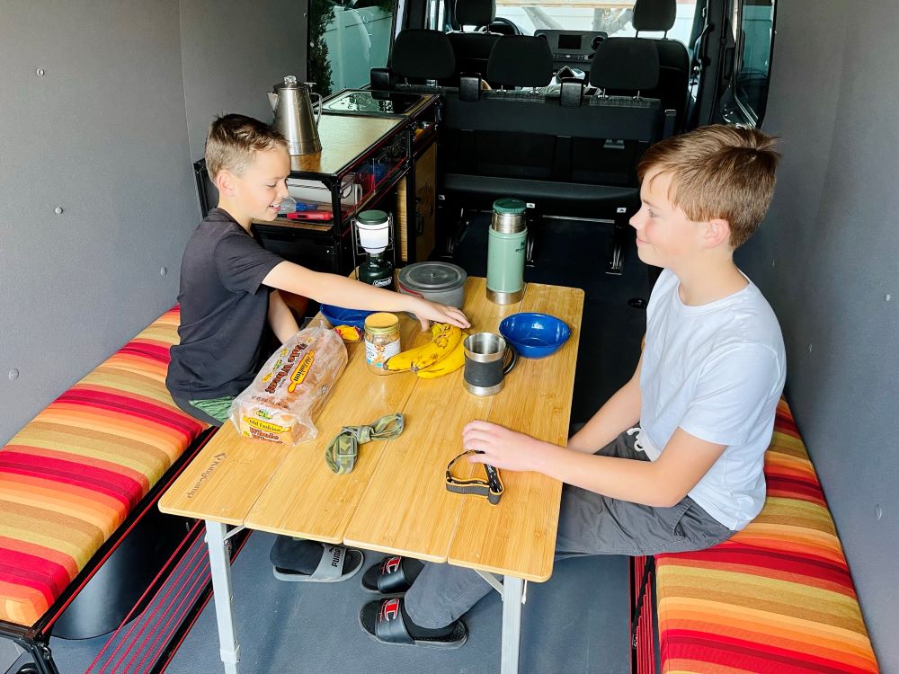 Another angle on the TNTvans Wheel Well Bench with Storage for Camper Vans, part of a DIY camper van conversion interior