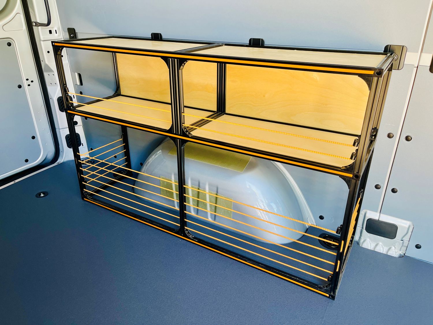 Angled view of the TNTvans Wheel Well Shelving Kit for Camper Vans, part of a DIY camper van conversion interior